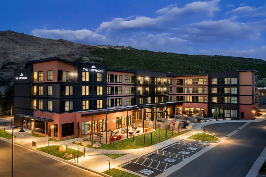 Nighttime view of a modern multi-story hotel labeled 